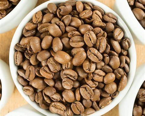 https://tastylicious.com/wp-content/uploads/2023/02/lightly-roasted-coffee-beans-in-white-cup-on-wooden-table.jpg